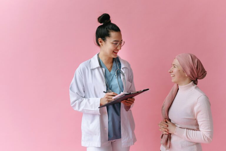 A doctor and cancer patient sharing a positive moment with empathy and care.
